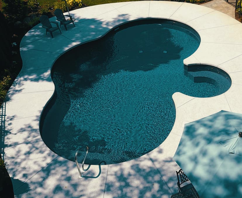 A luxurious in-ground gunite pool in a NYC brownstone backyard, featuring integrated landscaping and high-performance design.